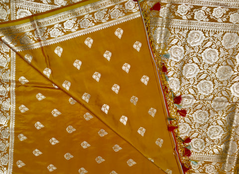 BKS119 Banarasi Mashru silk Saree in yellow. Comes with gold zari work. Comes with stitched blouse size 38 can be altered to size 42. Fall peco done.