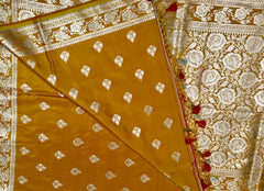 BKS119 Banarasi Mashru silk Saree in yellow. Comes with gold zari work. Comes with stitched blouse size 38 can be altered to size 42. Fall peco done.