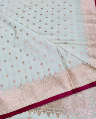 BKS131 Banarasi Mashru silk Saree in white.Comes with gold zari work. Comes with stitched blouse size 38 can be altered to size 42. Fall peco done.
