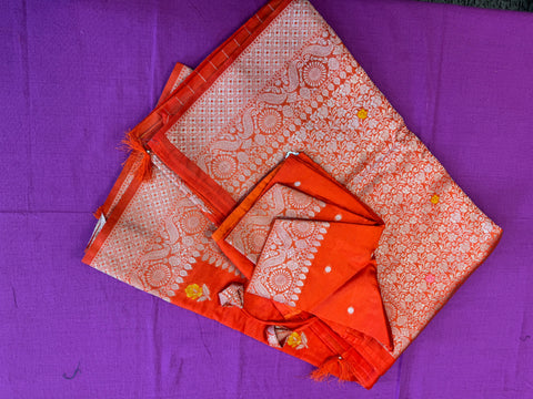 Banarasi Tussari saree in Orange with gold  zari border.Fall peco done. Comess with stitched blouse size 38 can be altered up to 44 size.