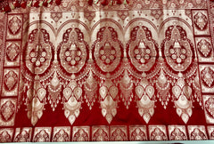 BKS121 Banarasi Mashru silk Saree in maroon. comes with gold zari work. Comes with stitched blouse size 38 can be altered to size 42. Fall peco done.