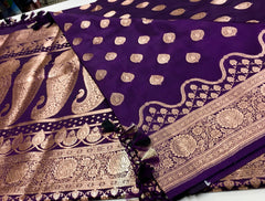 BKS129 Banarasi Mashru silk Saree in purple. Comes with gold zari work. Comes with stitched blouse size 38 can be altered to size 42. Fall peco done.