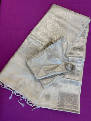 Semi Raw mango Saree in Off-white with Silver  Zari Border.Fall peco done. Comess with stitched blouse size 38 can be altered up to 44
