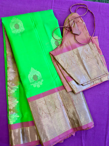 Pure kanchipuram Handloom Silk Saree in Parrot Green with Light Pink Zari border. Comes with Stitched Blouse size 38 can be altered up to 44