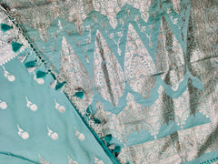 BKS118 Banarasi Mashru silk Saree in light blue. Comes with silver zari work. Comes with stitched blouse size 38 can be altered to size 42. Fall peco done.
