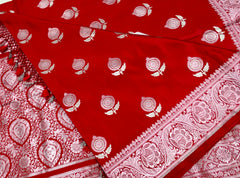 BKS128 Banarasi Mashru silk Saree in red. Comes with silver zari work. Comes with stitched blouse size 38 can be altered to size 42. Fall peco done.