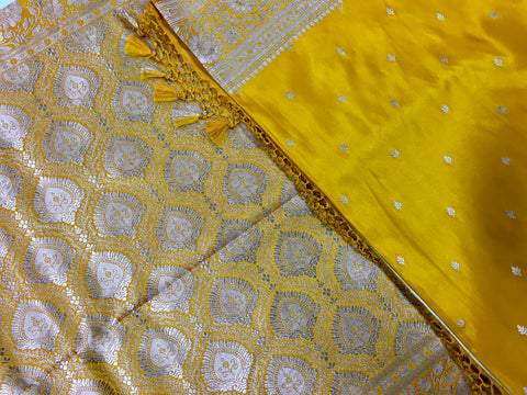 BKS117 Banarasi Mashru silk Saree in yellow. Comes with gold zari work. Comes with stitched blouse size 38 can be altered to size 42. Fall peco done.