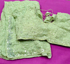 AFL3064 Partywear georgette saree in light green with silver sequin and bead embroidery work.Comes with stitched blouse size 40,can be altered to 44 size.Fall peco done.
