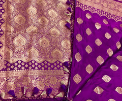 BKS115 Banarasi Mashru silk Saree in purple. Comes with gold zari work. Comes with stitched blouse size 38 can be altered to size 42. Fall peco done.