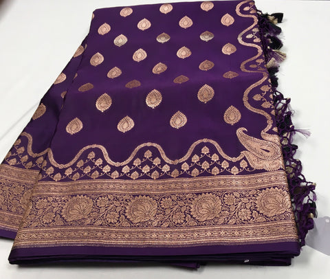 BKS129 Banarasi Mashru silk Saree in purple. Comes with gold zari work. Comes with stitched blouse size 38 can be altered to size 42. Fall peco done.