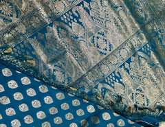 BKS124 Banarasi Mashru silk Saree in blue. Comes silver zari work. Comes with stitched blouse size 38 can be altered to size 42. Fall peco done.