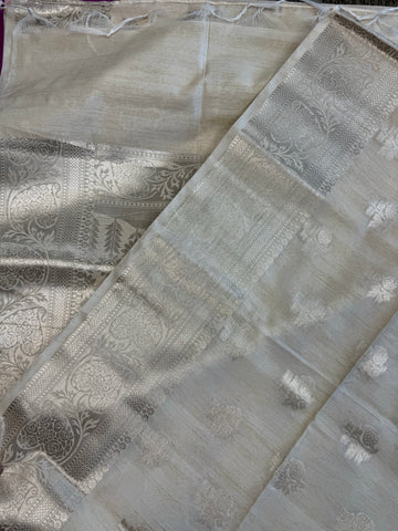 Semi Raw mango Saree in Off-white with Silver  Zari Border.Fall peco done. Comess with stitched blouse size 38 can be altered up to 44