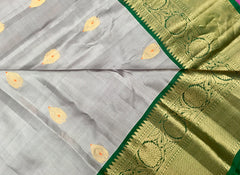 KSS420 Pure handloom kanchipuram silk Saree in gray with green gold zari border.comes with stitched blouse size 40,can be altered to 44 size.