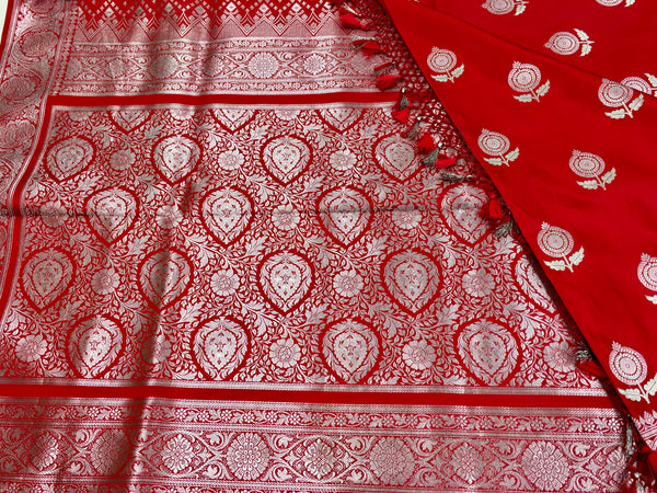 BKS128 Banarasi Mashru silk Saree in red. Comes with silver zari work. Comes with stitched blouse size 38 can be altered to size 42. Fall peco done.