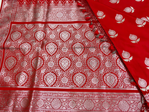BKS128 Banarasi Mashru silk Saree in red. Comes with silver zari work. Comes with stitched blouse size 38 can be altered to size 42. Fall peco done.