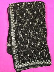 AFL3063 Partywear georgette saree in black with silver sequin and bead embroidery work.Comes with stitched blouse size 40,can be altered to 44 size.Fall peco done.