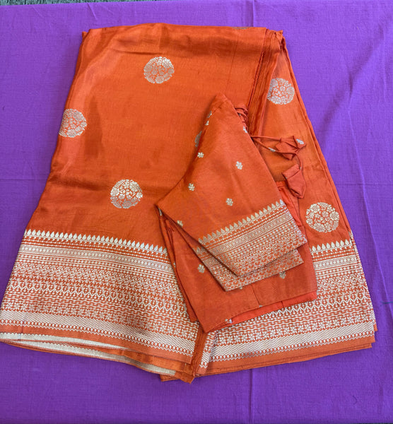 Maseru Silk Saree in Orange with Gold Zari border.Fall peco done. Comess with stitched blouse size 38 can be altered up to 44
