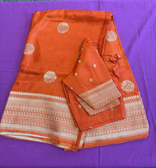 Maseru Silk Saree in Orange with Gold Zari border.Fall peco done. Comess with stitched blouse size 38 can be altered up to 44