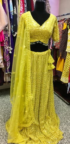 AFL4002 Wedding lehenga in yellow comes with heavy embroidery and sequin work.comes with net dupatta and stitched blouse.