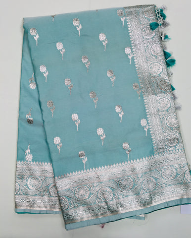 BKS118 Banarasi Mashru silk Saree in light blue. Comes with silver zari work. Comes with stitched blouse size 38 can be altered to size 42. Fall peco done.