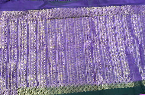 KSS438 kanchipuram silk Saree in black with purple gold zari border.comes with stitched blouse size 40,can be altered to 44 size.