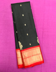 KSS428 Pure handloom kanchipuram silk Saree in black with red gold zari border.comes with stitched blouse size 40,can be altered to 44 size.