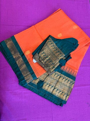 Korvai silk cotton saree in orange with Green gold zari  border.Fall peco done. Comes with stitched blouse size 38 can be altered up to 44 size.