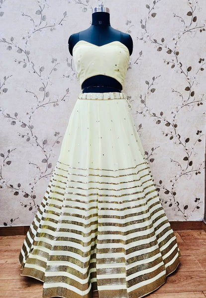AFL1055-Chiffon Lehenga in lemon yellow comes with vertical stripes gold Zari work on the border and  with Net Dupatta. Also Comes with a matching stitched corset blouse and jacket.