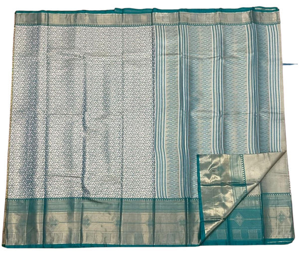 HPSS609 - Banarasi Soft Silk Saree in Silver with Sea Green Border. Comes with stitched blouse (size 38, can go up to size 42). Fall Peco Done.