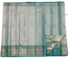 HPSS609 - Banarasi Soft Silk Saree in Silver with Sea Green Border. Comes with stitched blouse (size 38, can go up to size 42). Fall Peco Done.