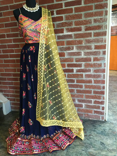 AFL1018 -pure chiffon embroided lehenga in deep blue multi color thread work. Comes with spaghetti blouse with foil mirror and thread work. Comes with a desinger net dupatta in yellow . Come with stitched blouse.