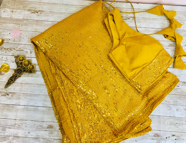 AM312 - imported sequin saree in yellow color.Comes with stitched blouse size 38, can be altered to size 42