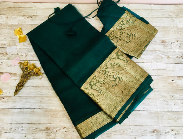 KSP205 - pure silk organza saree in bottle green with zari borders.Comes with stitched blouse size 38,can be altered to 42